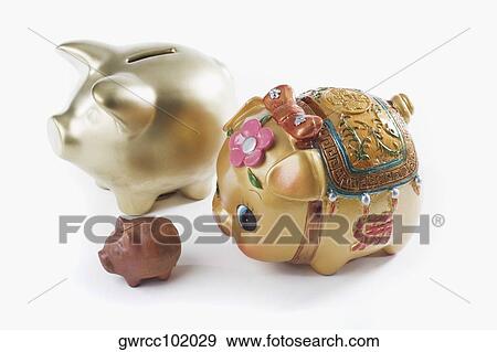 Stock Photo - Close-up of three piggy banks on white background. Fotosearch
