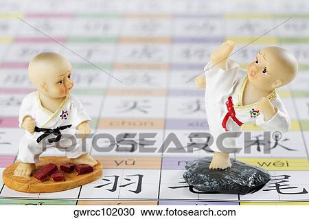 Close-up of two figurines View Large Photo Image Stock Image - Close-up of two figurines. Fotosearch