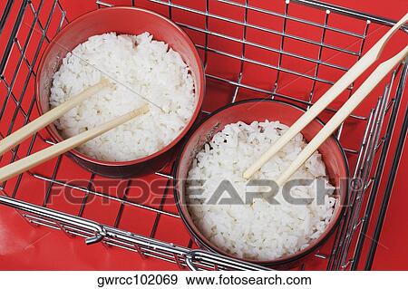 Close-up of white rice in bowls with chopsticks View Large Photo Image Stock Photo - Close-up of white rice in bowls with chopsticks. Fotosearch