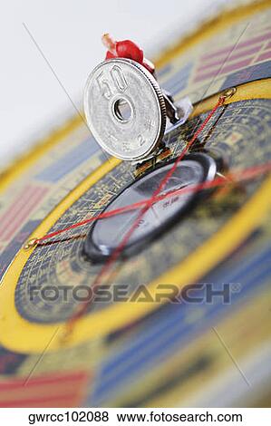 Figurine of manual worker working on a feng shui compass View Large Photo Image Stock Photo - Figurine of manual worker working on a feng shui compass. Fotosearch