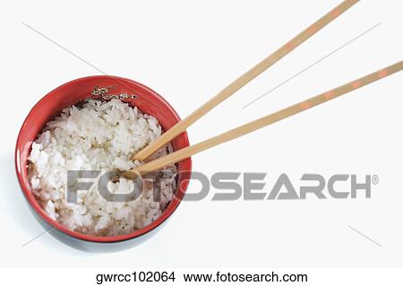 High angle view of a bowl of white rice with chopsticks View Large Photo Image Picture - High angle view of a bowl of white rice with chopsticks. Fotosearch