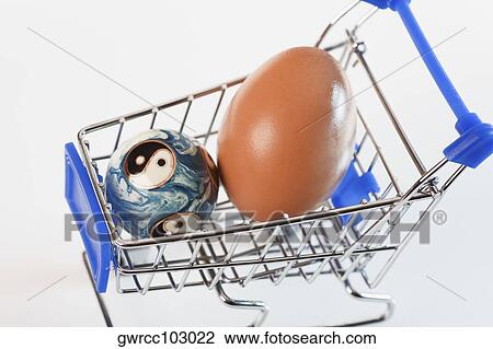 Close-up of a brown egg and a yin yang ball in a shopping cart View Large Photo Image Stock Image - Close-up of a brown egg and a yin yang ball in a shopping cart. Fotosearch