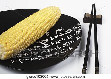 Close-up of a corn on a plate with chopsticks View Large Photo Image Stock Photography - Close-up of a corn on a plate with chopsticks. Fotosearch