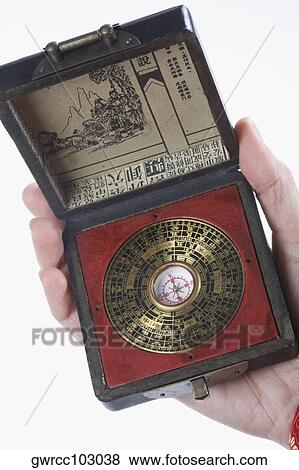 Close-up of a person's hand holding a feng shui compass View Large Photo Image Stock Photo - Close-up of a person's hand holding a feng shui compass. Fotosearch