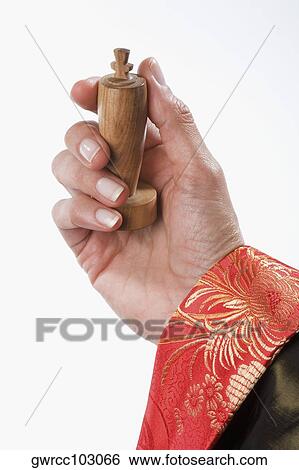 Close-up of a person's hand holding a king chess piece View Large Photo Image Stock Photograph - Close-up of a person's hand holding a king chess piece. Fotosearch