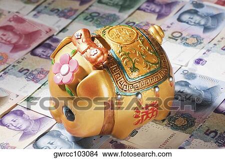 Close-up of a piggy bank on paper currency View Large Photo Image Picture - Close-up of a piggy bank on paper currency. Fotosearch
