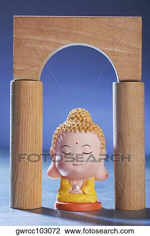 Close-up of figurine of Buddha under an arch View Large Photo Image Stock Image - Close-up of figurine of Buddha under an arch. Fotosearch