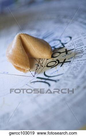 Close-up of fortune cookies on Chinese calendar View Large Photo Image Stock Photo - Close-up of fortune cookies on Chinese calendar. Fotosearch