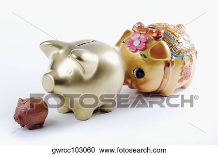 Close-up of three piggy banks in a row View Large Photo Image Stock Image - Close-up of three piggy banks in a row. Fotosearch