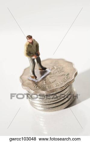 Figurine of a man on stack of Chinese coins View Large Photo Image Stock Photo - Figurine of a man on stack of Chinese coins. Fotosearch