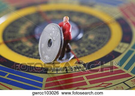 Figurine of manual worker working on a feng shui compass View Large Photo Image Stock Photograph - Figurine of manual worker working on a feng shui compass. Fotosearch