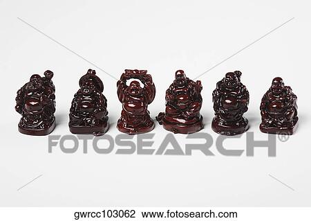 Figurines of Laughing Buddha in a row against white background View Large Photo Image Stock Image - Figurines of Laughing Buddha in a row against white background. Fotosearch