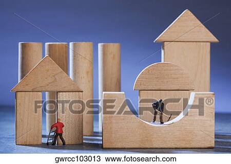 Figurines of manual workers constructing wooden house View Large Photo Image Stock Image - Figurines of manual workers constructing wooden house. Fotosearch