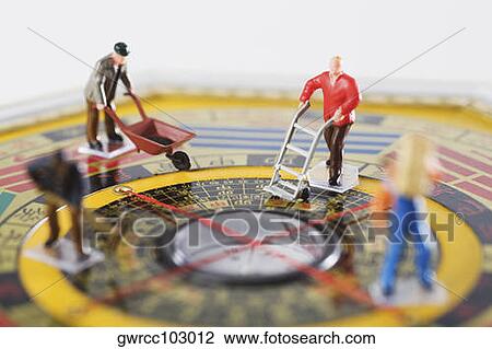 Figurines of manual workers working in feng shui compass View Large Photo Image Stock Image - Figurines of manual workers working in feng shui compass. Fotosearch
