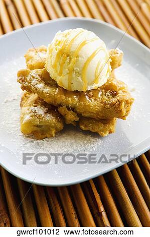 Close-up of a banana fritter served in a plate View Large Photo Image Stock Image - Close-up of a banana fritter served in a plate. Fotosearch