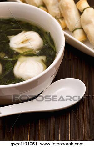 Close-up of Chinese dumplings in a bowl with sushi in the background View Large Photo Image Stock Image - Close-up of Chinese dumplings in a bowl with sushi in the background. Fotosearch