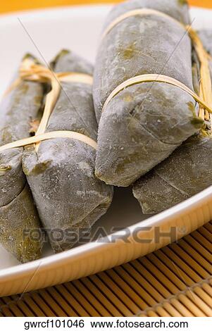 Close-up of Chinese dumplings wrapped in bamboo leaves View Large Photo Image Stock Photograph - Close-up of Chinese dumplings wrapped in bamboo leaves. Fotosearch