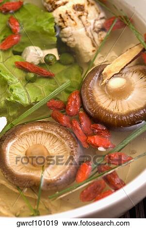 Close-up of Chinese soup with vegetables, mushrooms and pomegranate seeds in a bowl View Large Photo Image Stock Photo - Close-up of Chinese soup with vegetables, mushrooms and pomegranate seeds in a bowl. Fotosearch