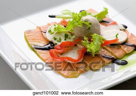 Stock Image - Close-up of salmon dish with palmito and soy sauce. Fotosearch