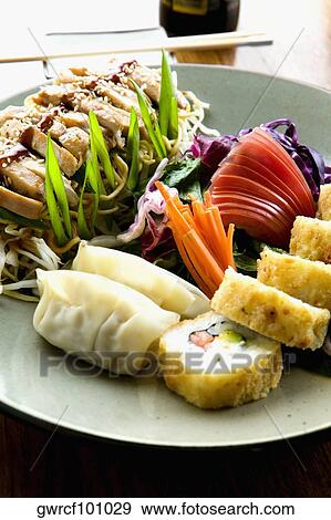 Stock Photo - Close-up of sushi with Chinese dumplings served in a plate. Fotosearch