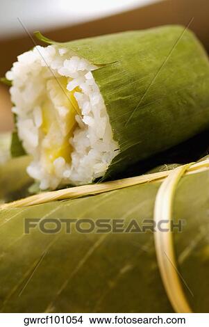 Rice dumplings wrapped in banana leaves View Large Photo Image Picture - Rice dumplings wrapped in banana leaves. Fotosearch