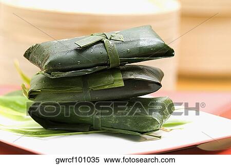 Rice dumplings wrapped in banana leaves View Large Photo Image Stock Photography - Rice dumplings wrapped in banana leaves. Fotosearch