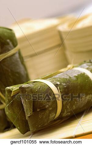 Stock Photography - Rice dumplings wrapped in banana leaves. Fotosearch
