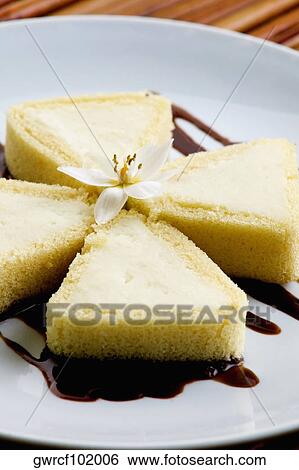 Close-up of a flower on Vanilla ice cream with chocolate cake View Large Photo Image Stock Photograph - Close-up of a flower on Vanilla ice cream with chocolate cake. Fotosearch