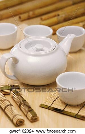 Close-up of a kettle with bowls and place mat View Large Photo Image Picture - Close-up of a kettle with bowls and place mat. Fotosearch