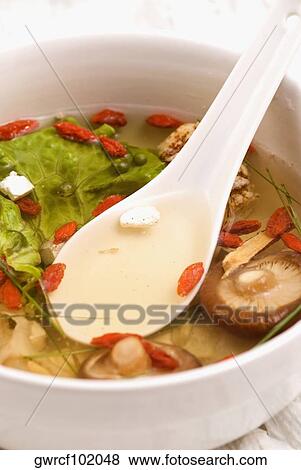 Close-up of Chinese soup with vegetables, mushrooms and pomegranate seeds in a bowl View Large Photo Image Stock Photo - Close-up of Chinese soup with vegetables, mushrooms and pomegranate seeds in a bowl. Fotosearch