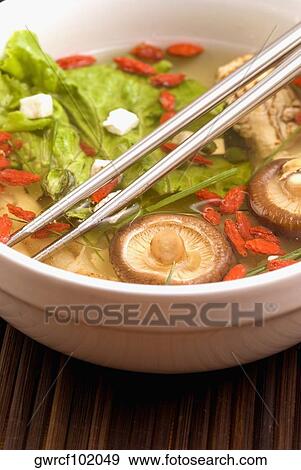 Close-up of Chinese soup with vegetables, mushrooms and pomegranate seeds in a bowl View Large Photo Image Stock Photo - Close-up of Chinese soup with vegetables, mushrooms and pomegranate seeds in a bowl. Fotosearch