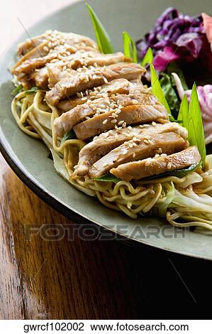 Stock Image - Close-up of pasta and salad in a plate. Fotosearch