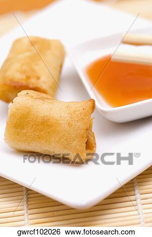 Close-up of spring rolls served in a tray View Large Photo Image Stock Photograph - Close-up of spring rolls served in a tray. Fotosearch