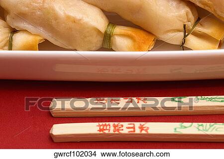 Close-up of sushi with chopsticks View Large Photo Image Picture - Close-up of sushi with chopsticks. Fotosearch