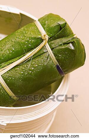 Rice dumpling wrapped in banana leaf View Large Photo Image Picture - Rice dumpling wrapped in banana leaf. Fotosearch