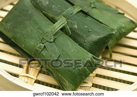 Rice dumplings wrapped in banana leaves View Large Photo Image Stock Image - Rice dumplings wrapped in banana leaves. Fotosearch
