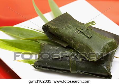 Rice dumplings wrapped in banana leaves View Large Photo Image Stock Photography - Rice dumplings wrapped in banana leaves. Fotosearch
