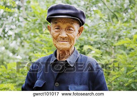 Portrait of a senior man wearing a flat cap, Zhigou, Shandong Province, China View Large Photo Image Stock Photo - Portrait of a senior man wearing a flat cap, Zhigou, Shandong Province, China. Fotosearch