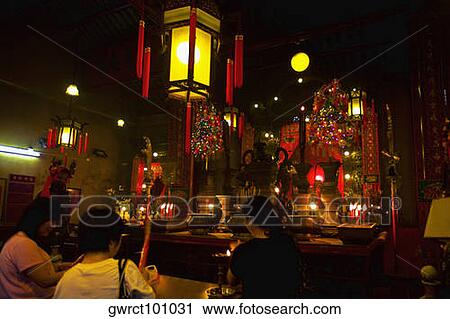 Rear view of three women praying in a temple, Man Mo Temple, Hong Kong, China View Large Photo Image Stock Image - Rear view of three women praying in a temple, Man Mo Temple, Hong Kong, China. Fotosearch