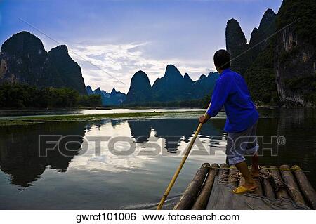 Side profile of a mature man rowing a wooden raft in a river, Li River, XingPing, Yangshuo, Guangxi Province, China View Large Photo Image Stock Photograph - Side profile of a mature man rowing a wooden raft in a river, Li River, XingPing, Yangshuo, Guangxi Province, China. Fotosearch