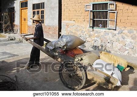 Stock Photography - Side profile of a senior man standing with a cart, Xingping, Yangshuo, Guangxi Province, China. Fotosearch