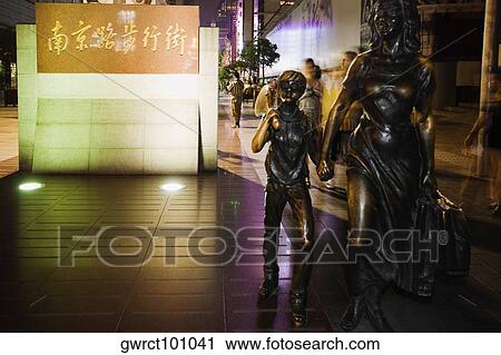 Statue of a woman with a child in a street, Nanjing Road, Shanghai, China View Large Photo Image Stock Image - Statue of a woman with a child in a street, Nanjing Road, Shanghai, China. Fotosearch