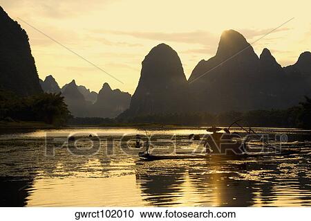Bamboo raft in a river with a hill range in the background, Guilin Hills, XingPing, Yangshuo, Guangxi Province, China View Large Photo Image Stock Image - Bamboo raft in a river with a hill range in the background, Guilin Hills, XingPing, Yangshuo, Guangxi Province, China. Fotosearch