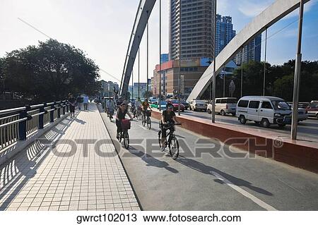 Group of people riding bicycles on the road, Hefei, Anhui Province, China View Large Photo Image Stock Image - Group of people riding bicycles on the road, Hefei, Anhui Province, China. Fotosearch