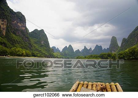 Hills along a river, Guilin Hills, XingPing, Yangshuo, Guangxi Province, China View Large Photo Image Stock Photograph - Hills along a river, Guilin Hills, XingPing, Yangshuo, Guangxi Province, China. Fotosearch