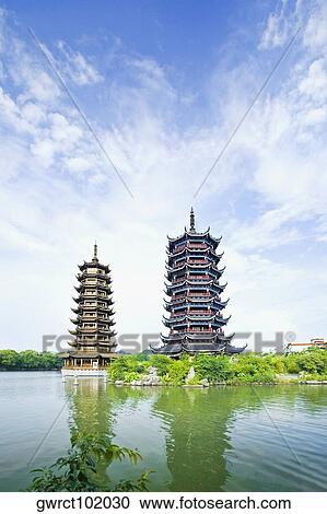 Stock Image - Low angle view pagoda at the waterfront, Sun and Moon Pagoda, Banyan Lake, Guilin, Guangxi Province, China. Fotosearch