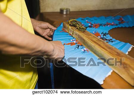 Mid section view of a person making folding fan, Fuli Village, Yangshuo, Guangxi Province, China View Large Photo Image Picture - Mid section view of a person making folding fan, Fuli Village, Yangshuo, Guangxi Province, China. Fotosearch