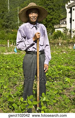 Portrait of a senior man standing in a field, Emerald Valley, Huangshan, Anhui Province, China View Large Photo Image Stock Image - Portrait of a senior man standing in a field, Emerald Valley, Huangshan, Anhui Province, China. Fotosearch