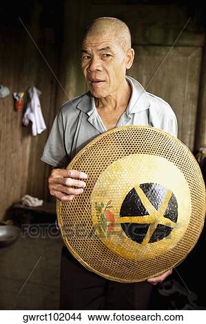 Senior man holding an Asian style conical hat, Jinkeng Terraced Field, Guangxi Province, China View Large Photo Image Picture - Senior man holding an Asian style conical hat, Jinkeng Terraced Field, Guangxi Province, China. Fotosearch