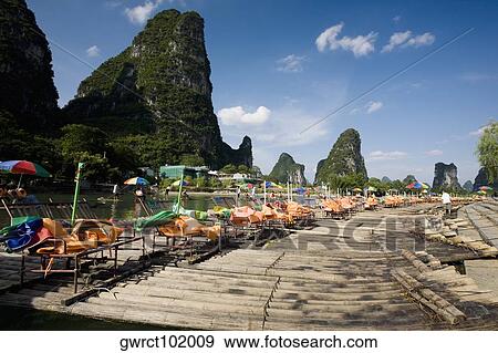 Tourist resort in a river, Guilin Hills, XingPing, Yangshuo, Guangxi Province, China View Large Photo Image Stock Photo - Tourist resort in a river, Guilin Hills, XingPing, Yangshuo, Guangxi Province, China. Fotosearch